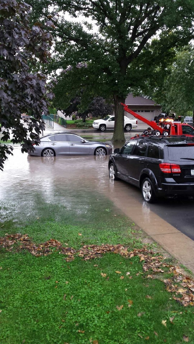 "This picture is of a car that stalled due to flooding. It is being towed from the water. The photo was taken on Lacasse Blvd in Tecumseh. Many basements have flooded on this street." by Tammy D.